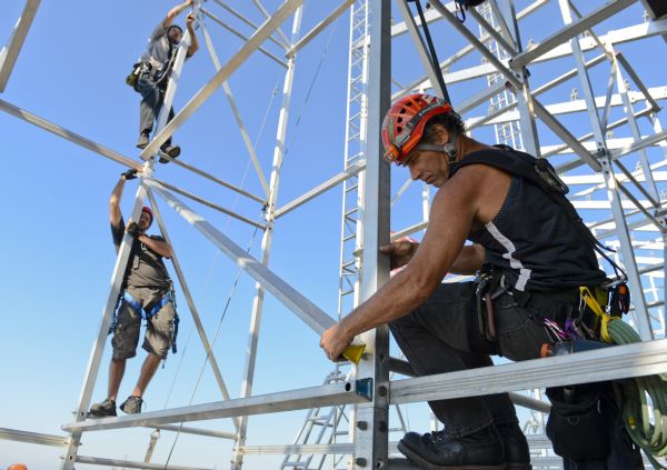 MAYPORT, Fla. (Nov. 4, 2012) Construction workers assemble bleacher scaffolding on the flight deck of the multipurpose amphibious assault ship USS Bataan (LHD 5) for the Navy-Marine Corps Classic basketball game scheduled for Nov. 9 between University of Florida and Georgetown University at Naval Station Mayport. The Navy-Marine Corps Classic is hosted by the city of Jacksonville which, along with its surrounding communities, has a long tradition of supporting Sailors and Marines. The game honors veterans, active and reserve service members, and military families. America's away team, the Navy and Marine Corps are reliable, flexible, and ready to respond worldwide on, above and below the sea as well as ashore. Join the conversation in social media using #BBallOnDeck. (U.S. Navy photo by Mass Communication Specialist Seaman Rob Aylward/Released) 121104-N-PW661-309 Join the conversation http://www.facebook.com/USNavy http://www.twitter.com/USNavy http://navylive.dodlive.mil